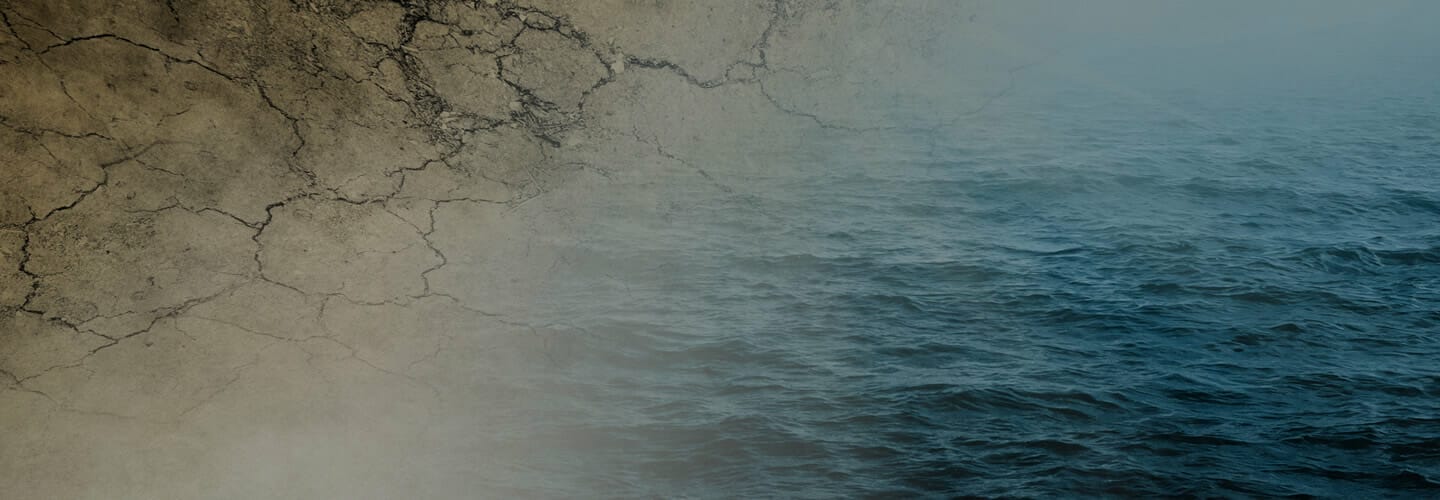 Parched and cracked earth grading into water